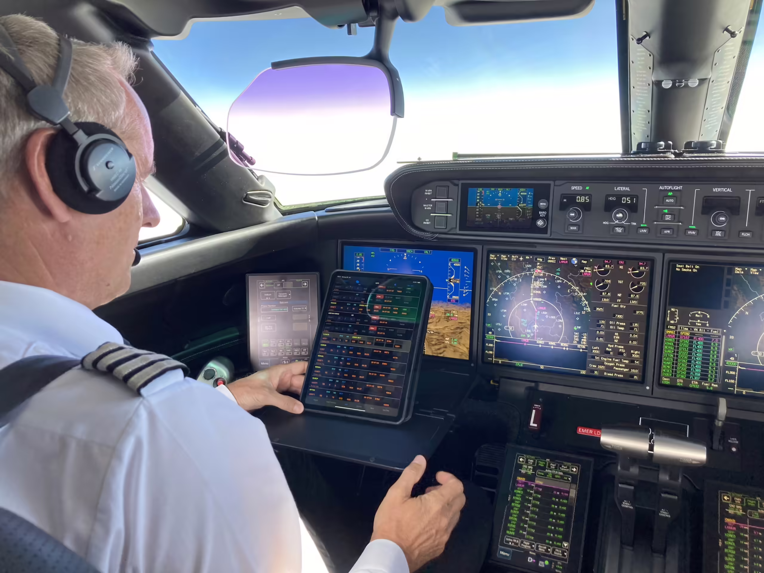 Pilot in cockpit using smartEFB app on a tablet for navigation and flight data integration, with cockpit displays and controls visible.